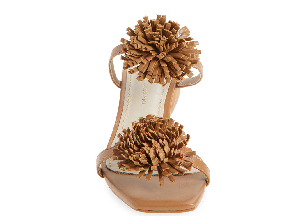 Brown sandal with pom-pom details on a cylindrical block heel - front view