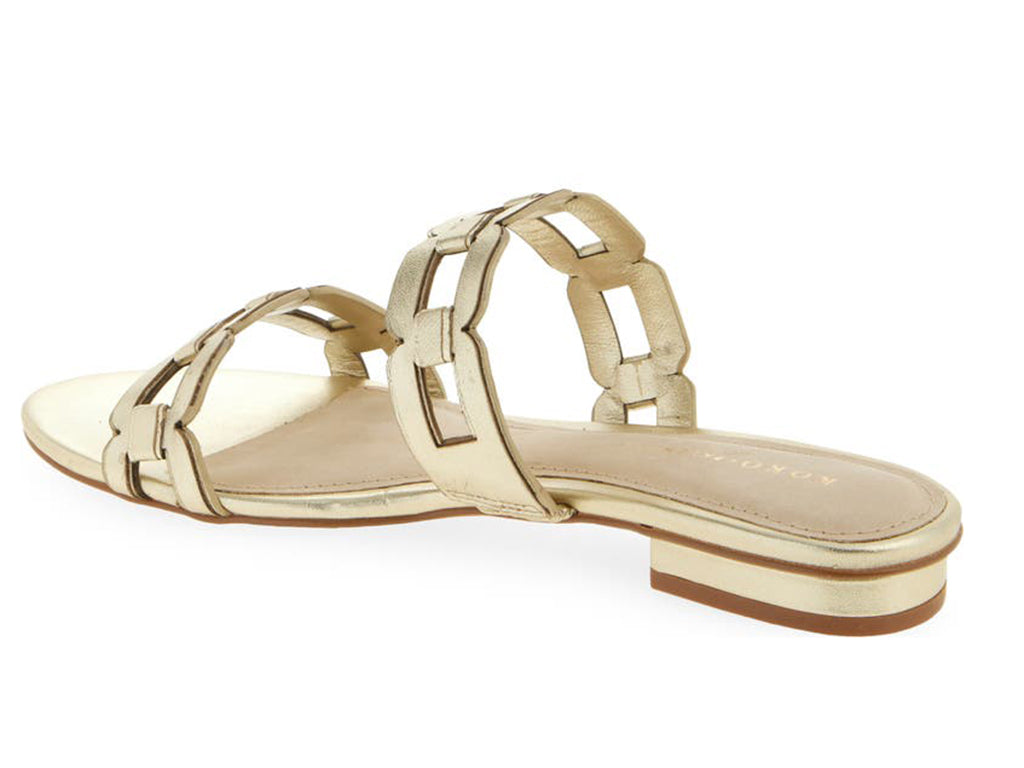 gold sandal with strap details on a low heel- view of the heel and strap