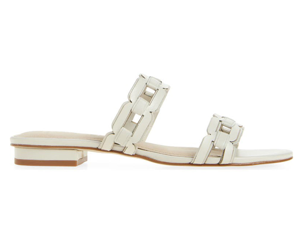 White sandal with strap details on a low heel - side view