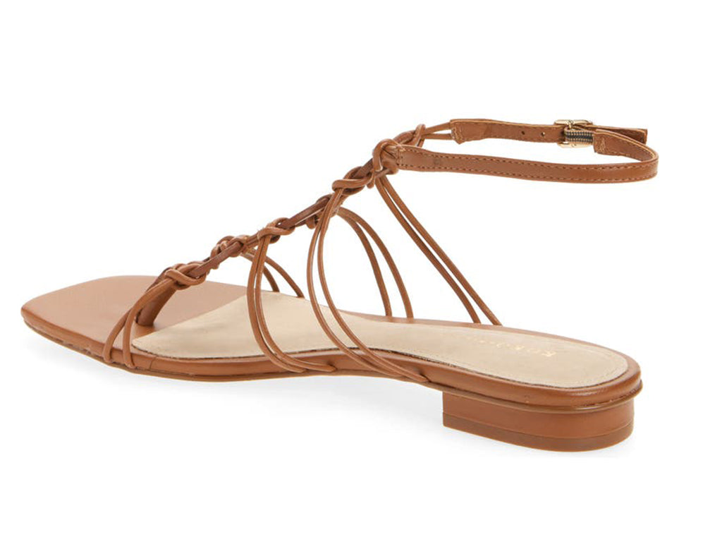 tan colored sandal with thin straps, ankle strap, and low heel, view from the side featuring heel and ankle strap