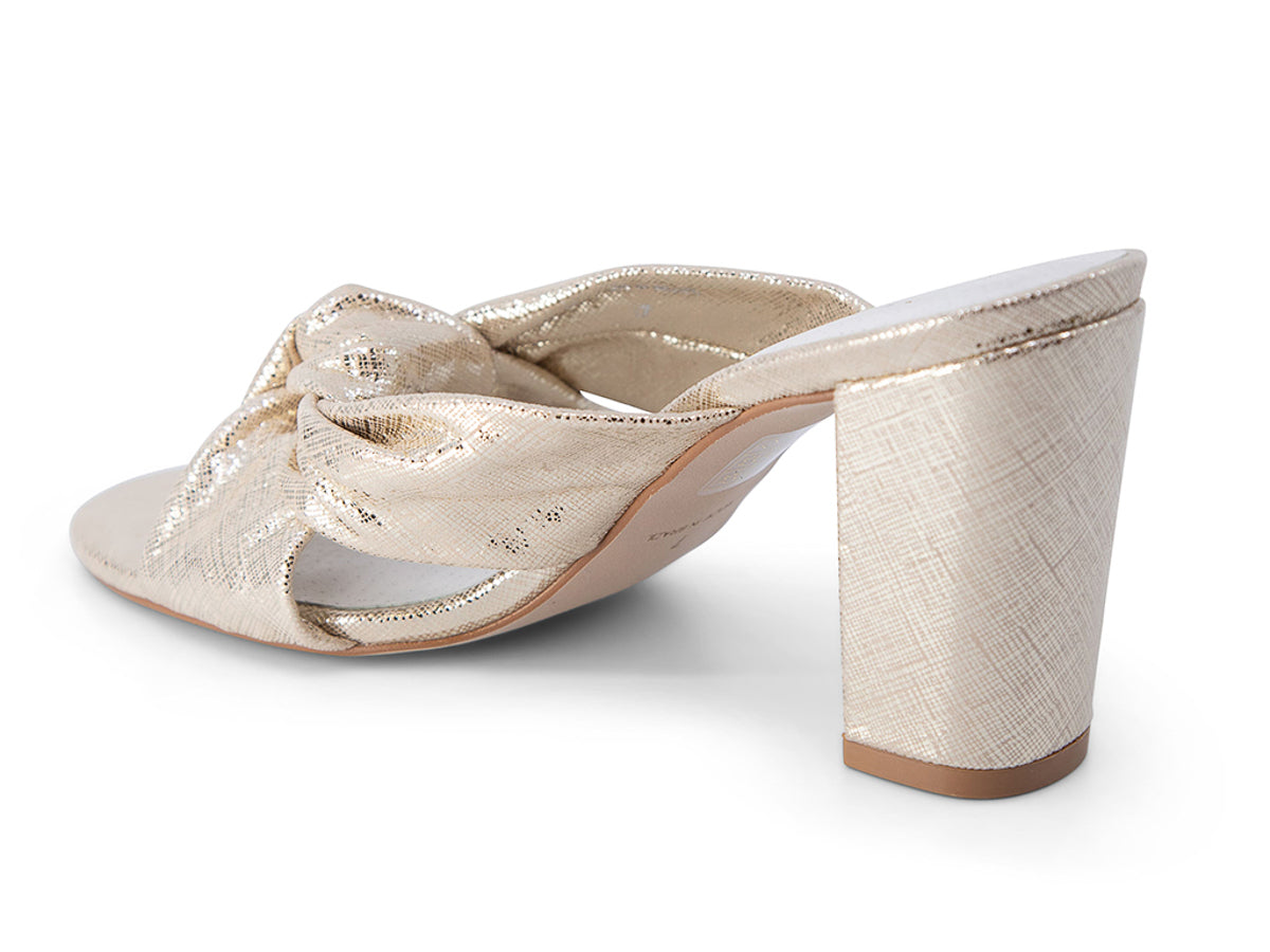 Gold high-heeled sandal with a bow on a white background back and heel view