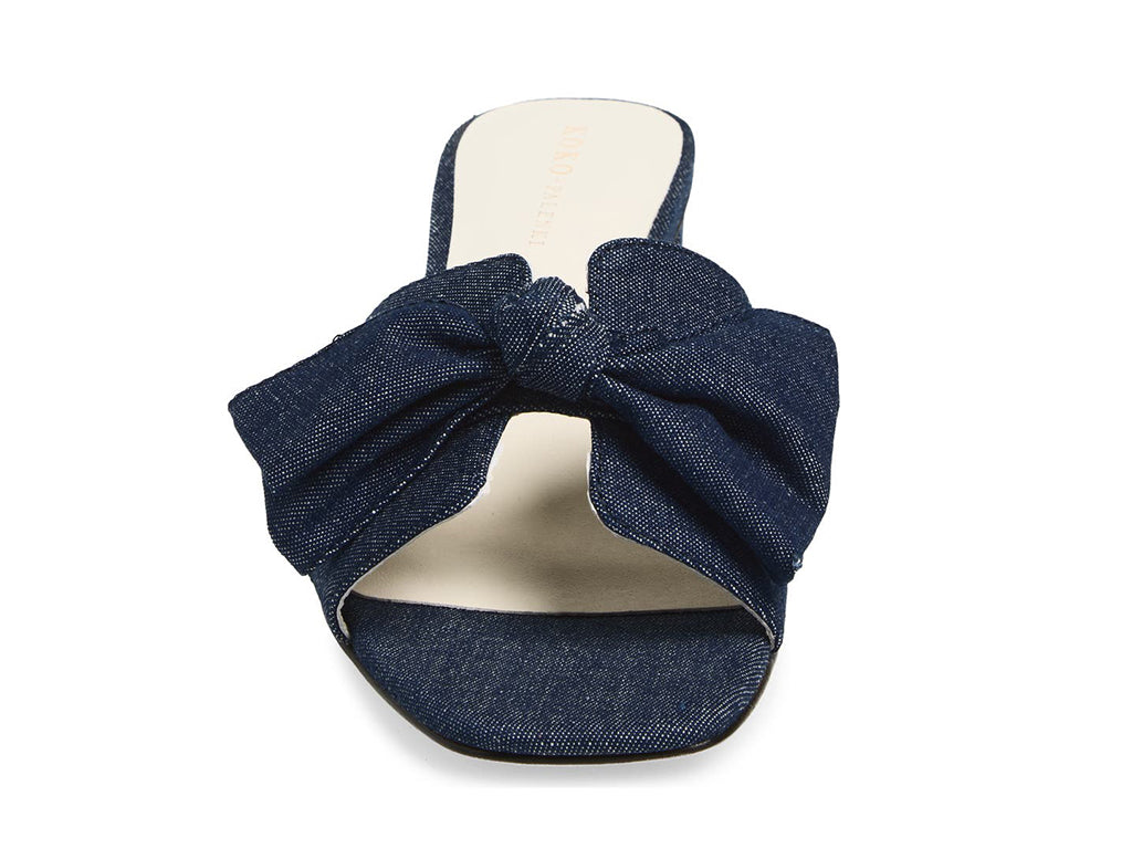 Blue denim slide sandal with a bow - front view of the bow and toe opening