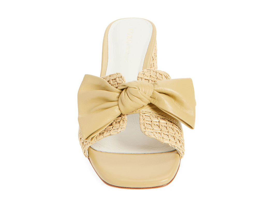 Beige sandal with woven details and a bow on a block heel - front view of the upper and the bow 