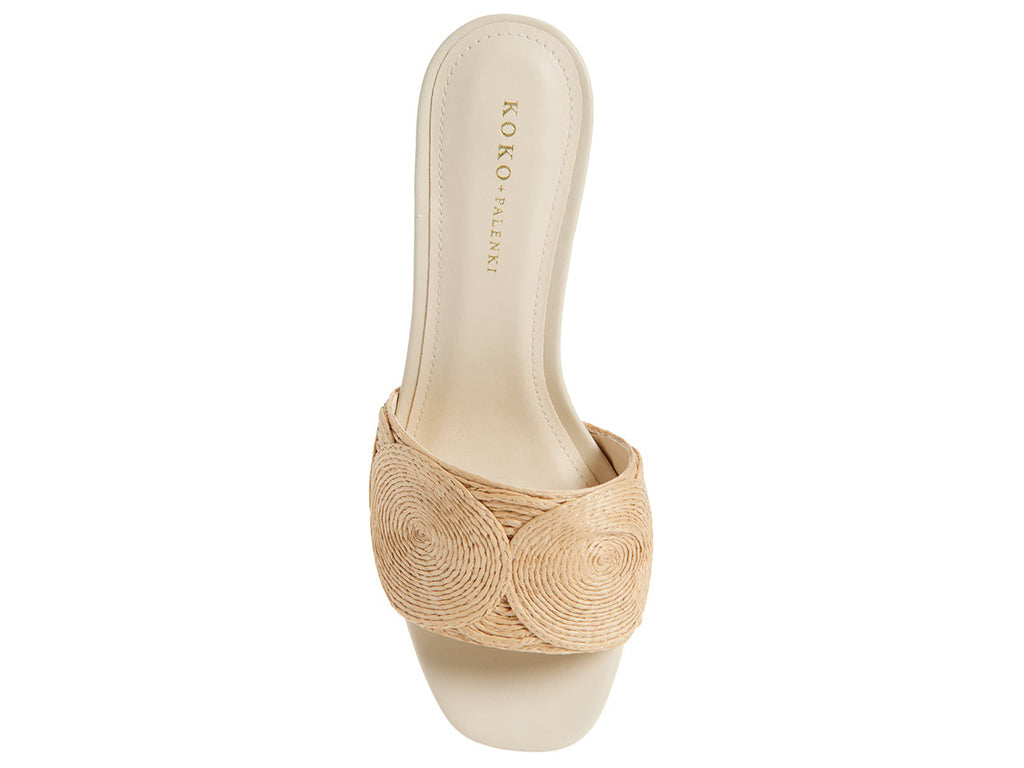 Slide sandal with a gold flared heel and one strap circle pattern raffia upper - view of the upper from the top